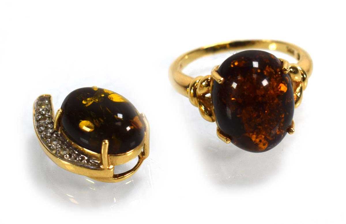 Lot 693 - A 14ct yellow gold ring set amber type stone...