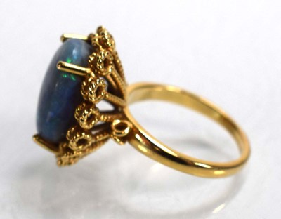 Lot 694 - A 14ct yellow gold ring set oval opal in a...