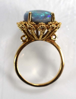 Lot 694 - A 14ct yellow gold ring set oval opal in a...