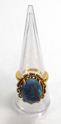 Lot 694 - A 14ct yellow gold ring set oval opal in a...