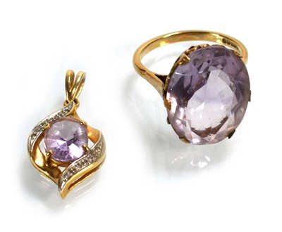 Lot 695 - A 9ct yellow gold ring set pale amethyst type...