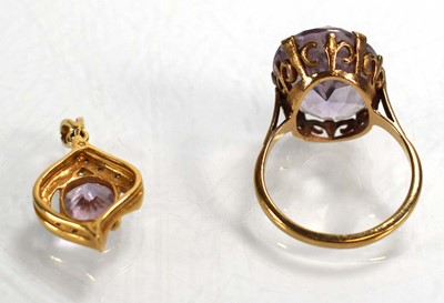 Lot 695 - A 9ct yellow gold ring set pale amethyst type...