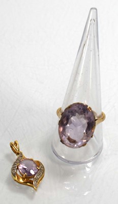 Lot 695 - A 9ct yellow gold ring set pale amethyst type...