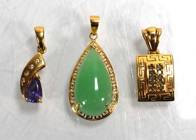 Lot 699 - Three 14ct yellow gold pendants set green...