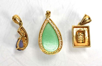 Lot 699 - Three 14ct yellow gold pendants set green...