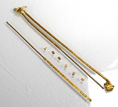 Lot 701 - An 18ct yellow gold triple strand engraved...