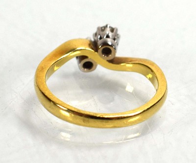 Lot 717 - An 18ct yellow gold crossover ring set two...