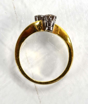 Lot 717 - An 18ct yellow gold crossover ring set two...