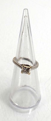 Lot 707 - An 18ct white gold ring set princess cut...