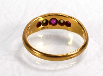 Lot 711 - An 18ct yellow gold ring set three graduated...