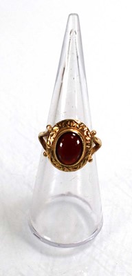 Lot 712 - A 9ct yellow gold ring set cabochon garnet in...