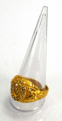Lot 715 - A yellow metal signet ring set clear stones...
