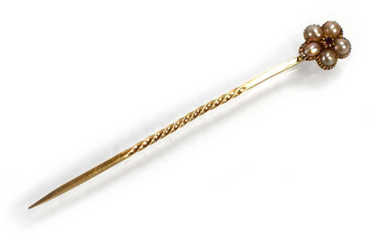 Lot 716 - A yellow metal stick pin set ruby and seed...