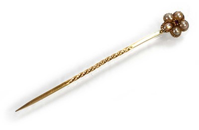 Lot 716 - A yellow metal stick pin set ruby and seed...