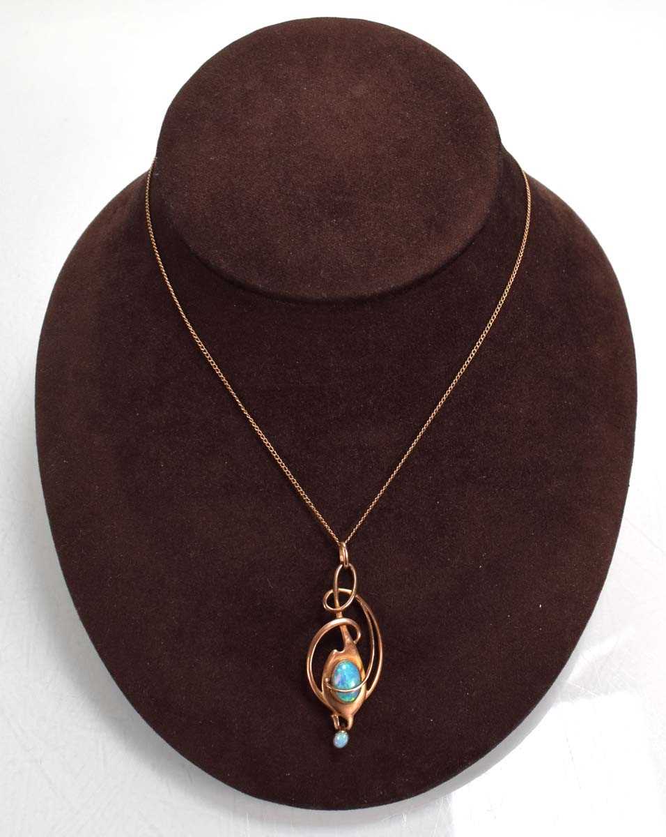 Lot 729 - A yellow metal necklace suspending a 9ct rose...