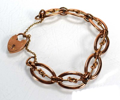 Lot 730 - A 9ct rose gold oval link bracelet with heart...