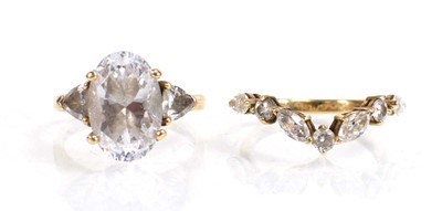 Lot 724 - A 9ct yellow gold ring set oval and trilliant...