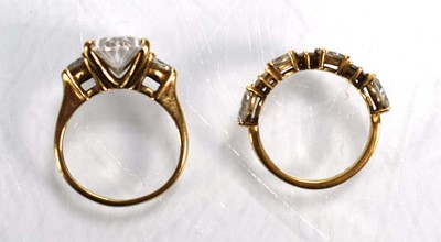 Lot 724 - A 9ct yellow gold ring set oval and trilliant...