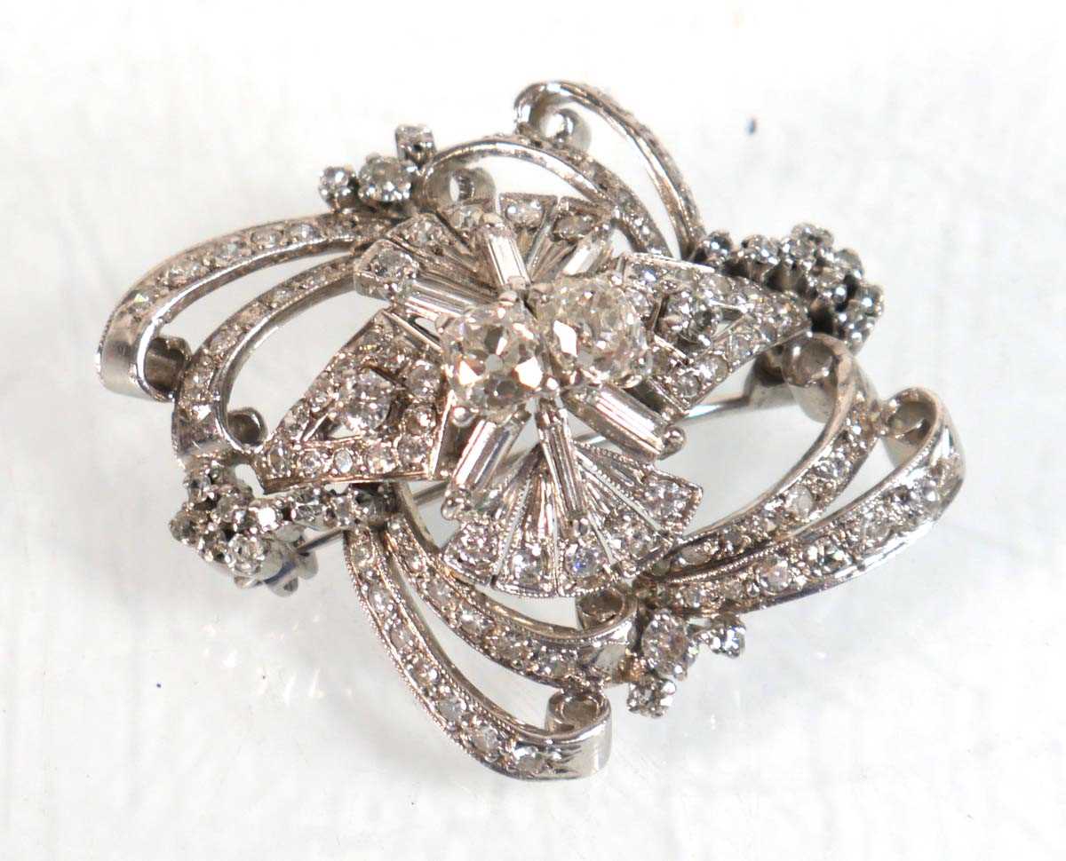 Lot 751 - A white metal openwork brooch centrally set...