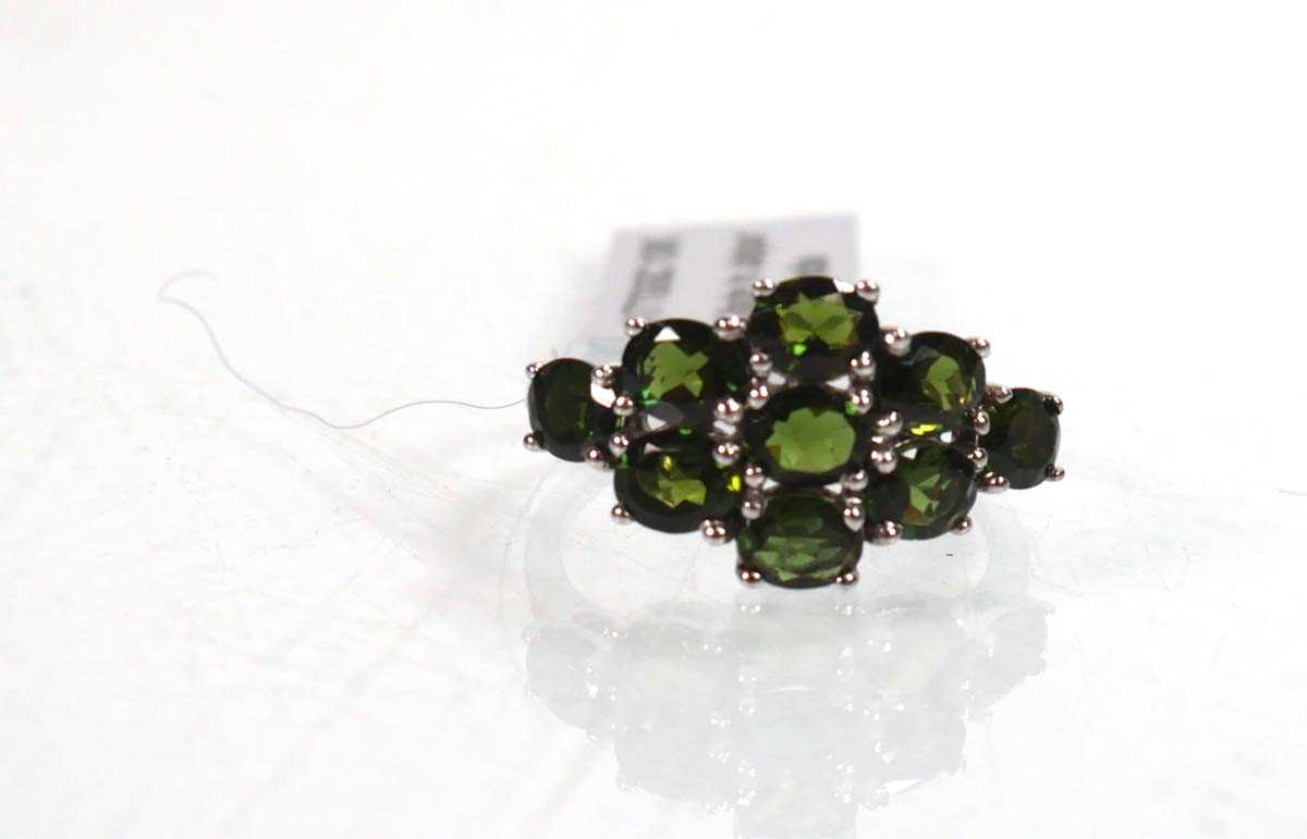 Lot 762 - A 9ct white gold ring set nine oval green...