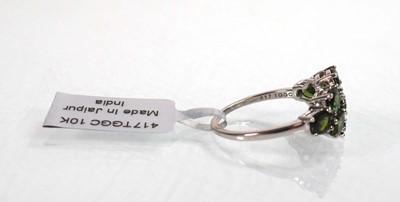 Lot 762 - A 9ct white gold ring set nine oval green...