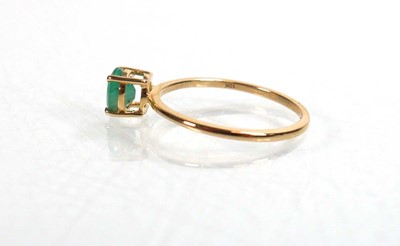 Lot 763 - A 9ct yellow gold ring set oval emerald within...