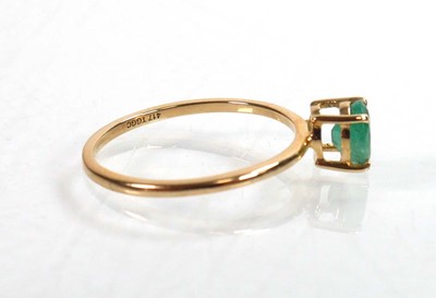 Lot 763 - A 9ct yellow gold ring set oval emerald within...
