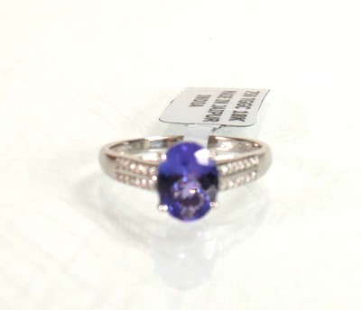 Lot 764 - An 18ct white gold ring set oval tanzanite...
