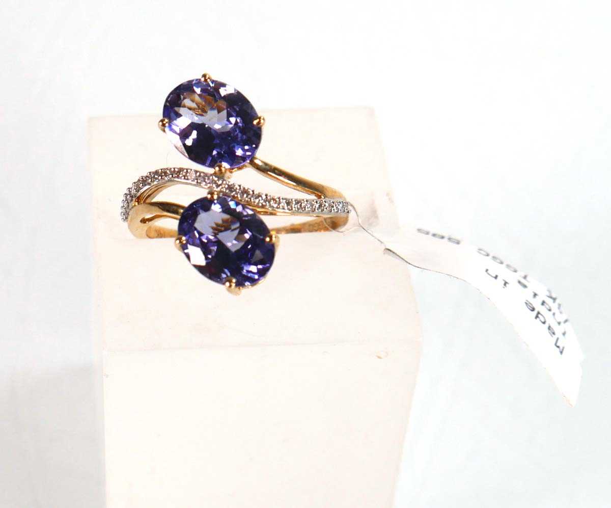 Lot 766 - A 9ct yellow gold crossover ring set two oval...