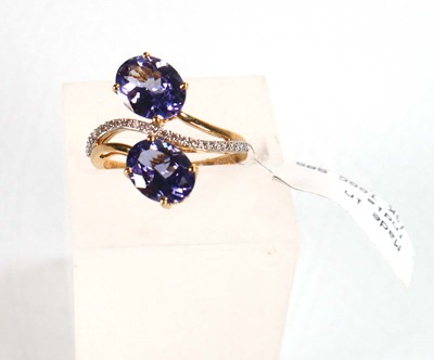 Lot 766 - A 9ct yellow gold crossover ring set two oval...