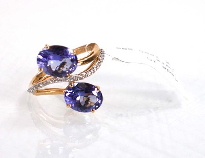 Lot 766 - A 9ct yellow gold crossover ring set two oval...