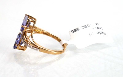 Lot 766 - A 9ct yellow gold crossover ring set two oval...