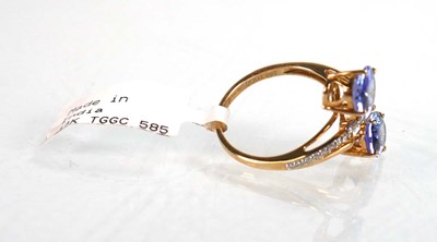 Lot 766 - A 9ct yellow gold crossover ring set two oval...