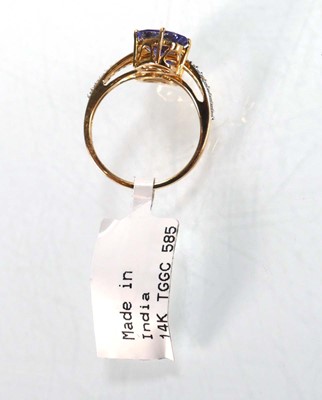 Lot 766 - A 9ct yellow gold crossover ring set two oval...