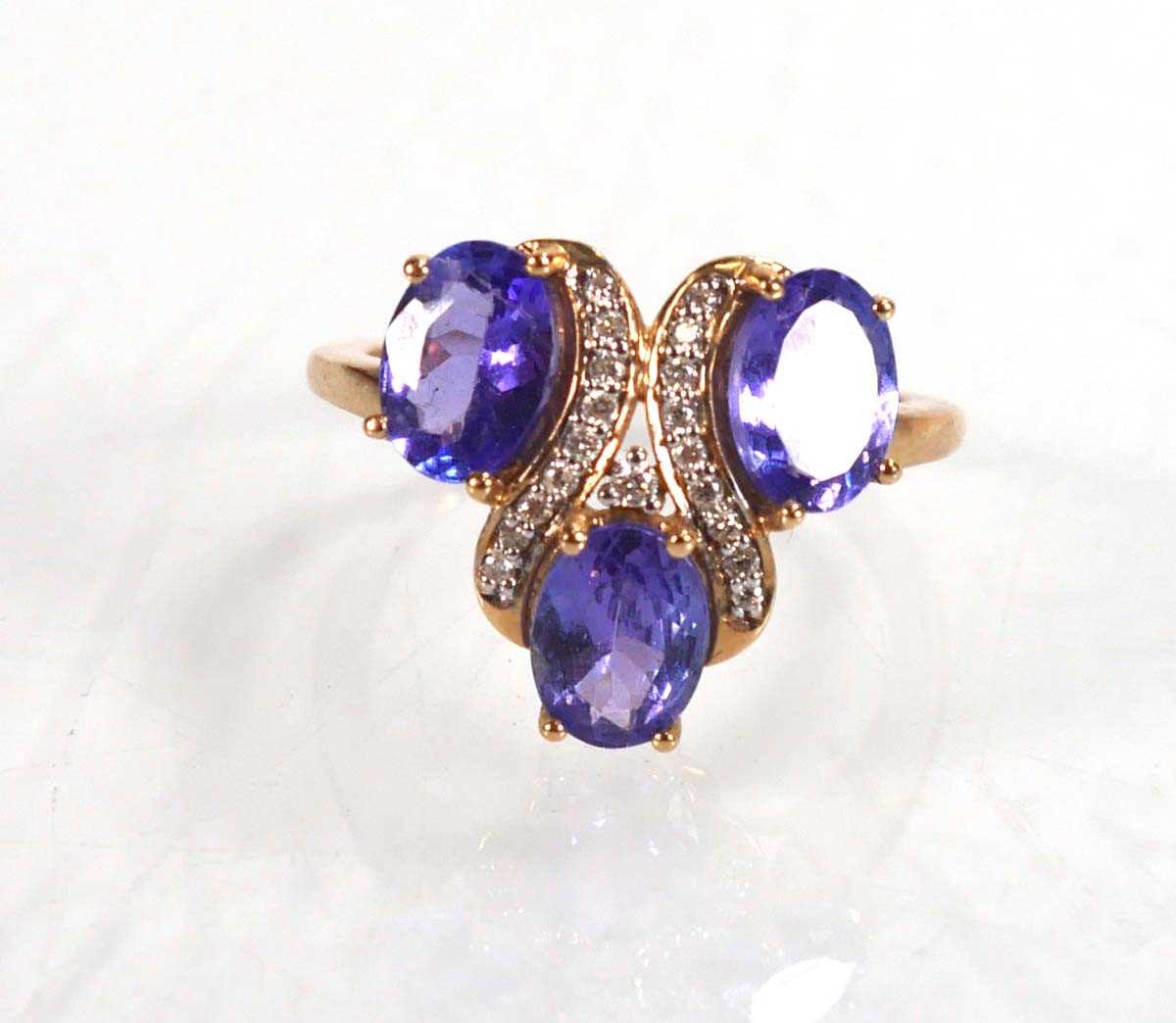 Lot 767 - A 9ct yellow gold ring set three oval...
