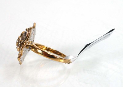 Lot 768 - A 9ct yellow gold flowerhead ring set layers...