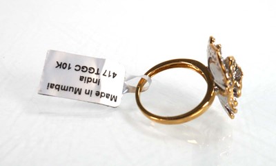 Lot 768 - A 9ct yellow gold flowerhead ring set layers...