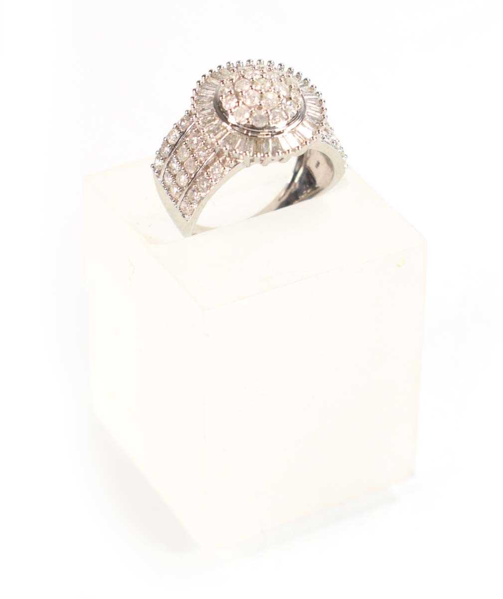 Lot 771 - A 9ct white gold ring set small diamonds in a...