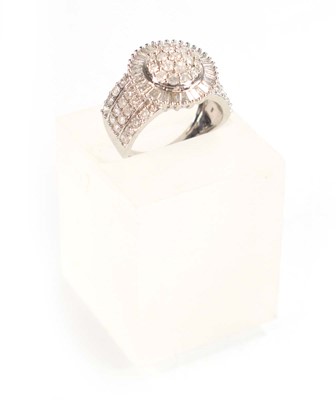 Lot 771 - A 9ct white gold ring set small diamonds in a...