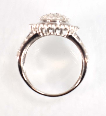 Lot 771 - A 9ct white gold ring set small diamonds in a...