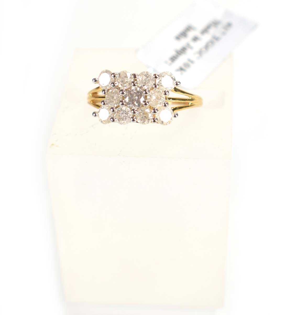 Lot 774 - A 9ct yellow gold ring set three rows of small...