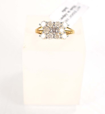 Lot 774 - A 9ct yellow gold ring set three rows of small...