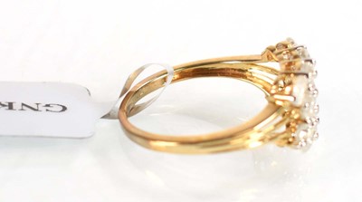 Lot 774 - A 9ct yellow gold ring set three rows of small...
