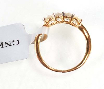 Lot 774 - A 9ct yellow gold ring set three rows of small...