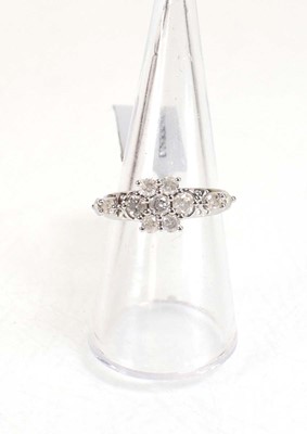 Lot 776 - A 9ct white gold flowerhead ring set small...