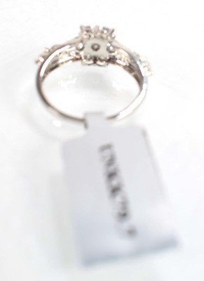 Lot 776 - A 9ct white gold flowerhead ring set small...