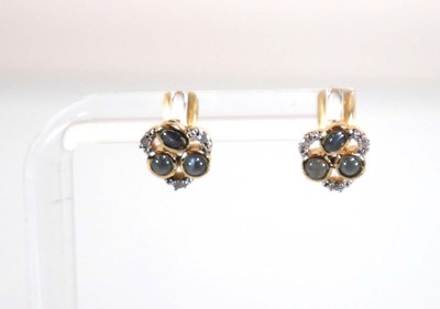 Lot 781 - A pair of 9ct yellow gold ear studs set small...