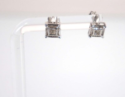 Lot 781 - A pair of 9ct yellow gold ear studs set small...