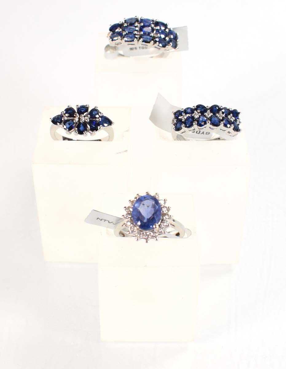 Lot 793 - Four silver dress rings set blue stones,...