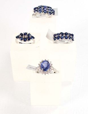 Lot 793 - Four silver dress rings set blue stones,...